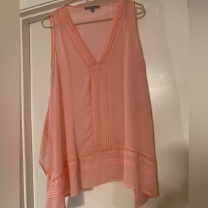 Sheer sleeveless top with side splits.